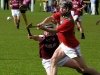 Clear and present - Damien Maher (St. Martins) about to strike the sliotar as Dicksboros Derek O\'Gorman dives into block.
