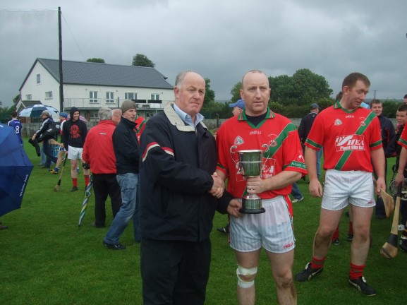 Dermot Lawlor recevies the cup from Nothern Board chairman Donal Brennan