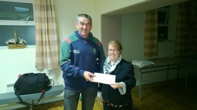 Richard O'Shea presenting Annemarie Nolan with a winning cheque.